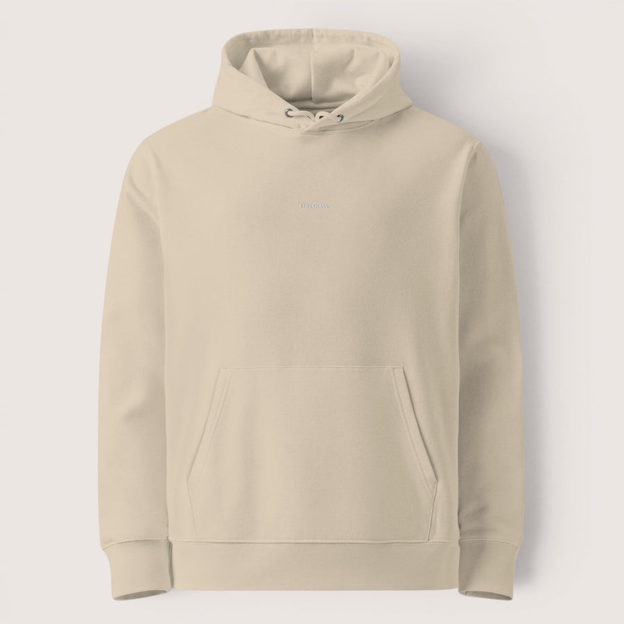 Sweat à capuche unisexe ETHIKKALL beige en coton organique, avec logo discret brodé sur la poitrine et poche kangourou.